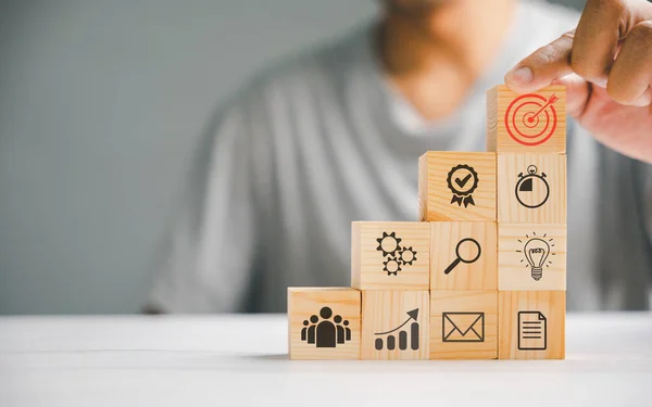 depositphotos_676190702-stock-photo-hand-skillfully-arranging-wooden-blocks